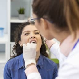 Woman having her tonsils looked at